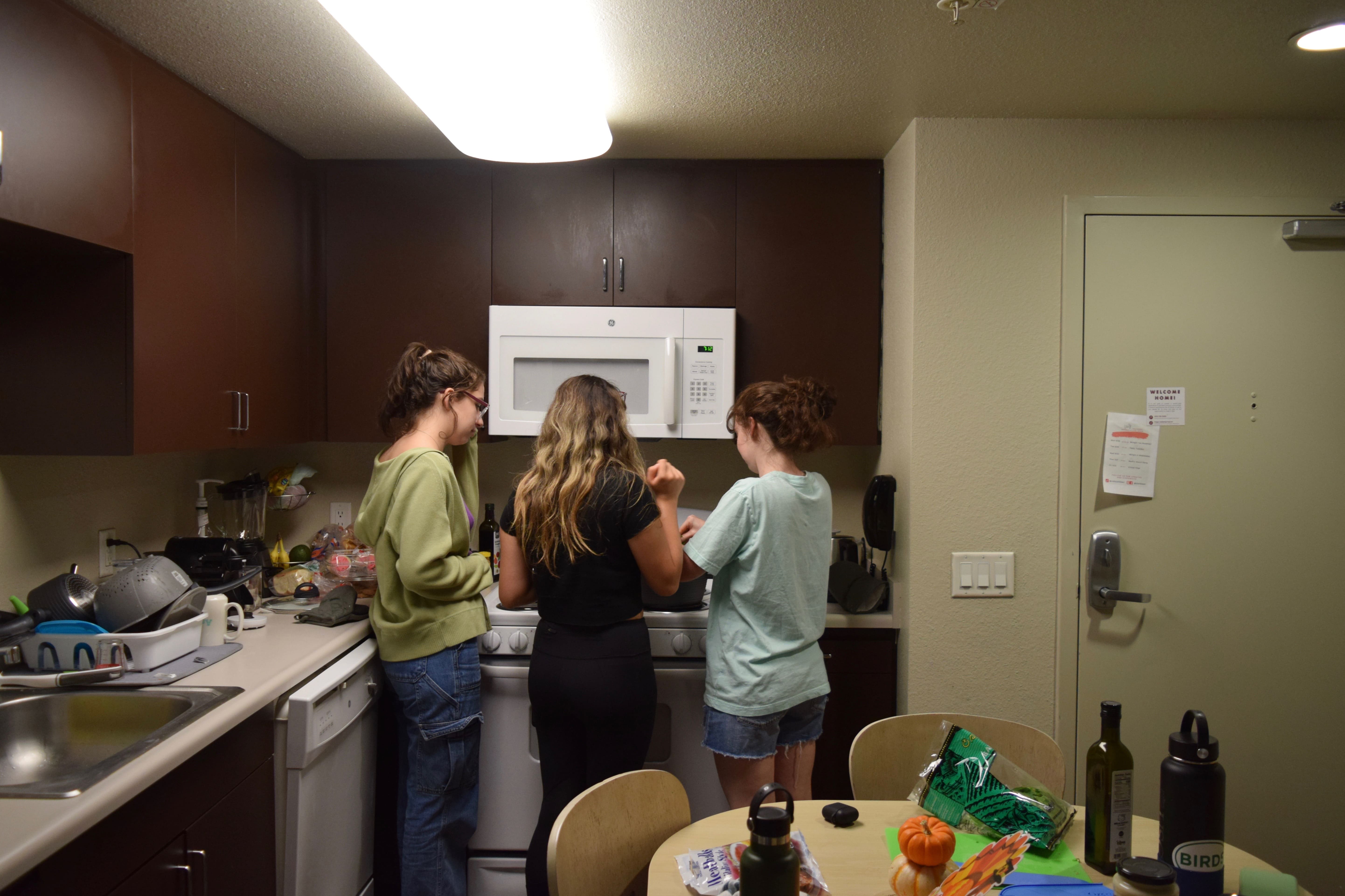 Friends crowded in the kitchen